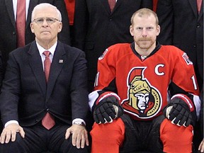 OTTAWA, ON. APRIL 19, 2012 --- The Ottawa Senators sat for their Annual Team Photo on Thursday at Scotiabank Place - the night after they tied up their playoff series with New York at 2-2. Here,  team captain Daniel Alfredsson (centre) sandwiched between GM Bryan Murray (left) and owner Eugene Melnyk (OTTAWA CITIZEN/JULIE OLIVER) #108534. SPORTS.