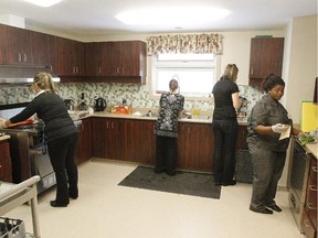 Staff prepare food for the opening of the new Interval House, a shelter for abused women, in Ottawa, February 16, 2012.