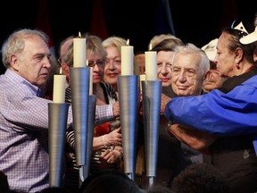 Holocaust survivors gather to light a candle during National Holocaust Remembrance Day ceremonies at the Canadian War Museum.