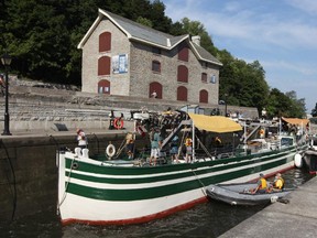 The Lois McClure, a reproduction 1862-class canal schooner, makes it way through the lRideau Canal Locks, in Ottawa, on July 31, 2012. The Lois McClure is a replica of commercial boats that plied the interior waters in Canada and the U.S. during the 19th century and is  towed through the Rideau Canal by the C. L. Churchill tugboat, a replica from the end of the 19th century. They are travelling from Ottawa to Kingston.