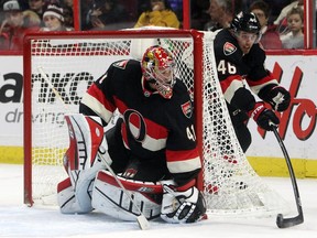 Ottawa Senators Patrick Wiercioch makes a stop at the side of the net of goalie Craig Anderson during NHL game action.