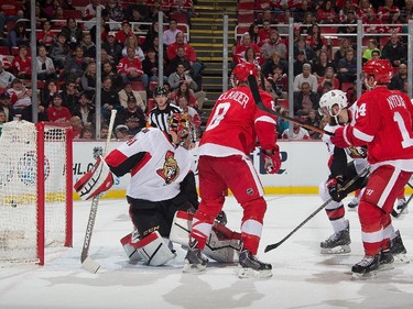 Gustav Nyquist #14 of the Detroit Red Wings shoots a rebound past goaltender Craig Anderson #41 of the Ottawa Senators.