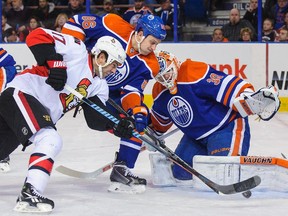 Nikita Nikitin #86 and Ben Scrivens #30 of the Edmonton Oilers defend net against David Legwand #17 of the Ottawa Senators during an NHL game at Rexall Place on November 13, 2014 in Edmonton, Alberta.