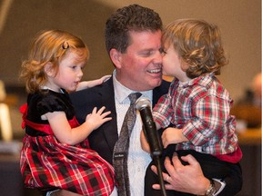 Outgoing Ottawa city councillor Steve Desroches is nuzzled by his two year old twin Max with Zoe in his right arm while he gives his goodbye speech during the council meeting Wednesday morning. Assignment - 11911 1Photo taken at 11:26 on November 26. (Wayne Cuddington/ Ottawa Citizen)