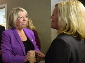 Pat Perkins celebrates with Christine Elliott at the Conservative headquarters on Monday Nov. 17, 2014 in Whitby, Ont.