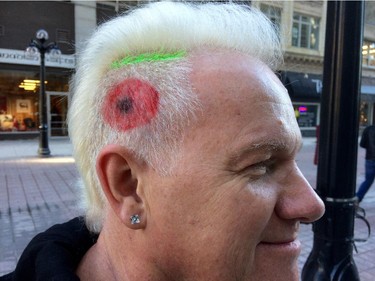 Peter Brosowski wears poppy art in his hair as he attends Remembrance Day ceremonies at the National War Memorial.