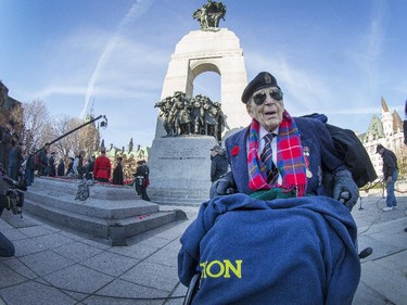 Peter Platt, 101, who served with REME (engineers) landed at Normandy and fought through Belgium and Holland manages to get his son to take a photo of him in front the War Memorial as the annual Remembrance Day Ceremony