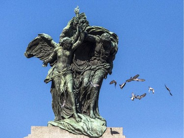 Pigeons fly off National War Memorial during the Remembrance Day ceremony in Ottawa Tuesday, November 11, 2014.