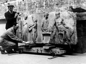 This file photo shows the Elgin Marbles being handled by porters after being stored in an underground tunnel for safety during the Second World War.