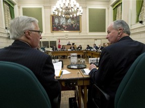 Minister of National Defence Rob Nicholson (r) speaks briefly with deputy minister Richard Fadden (l) before appearing at the Commons Committee on National Defence Nov. 25.