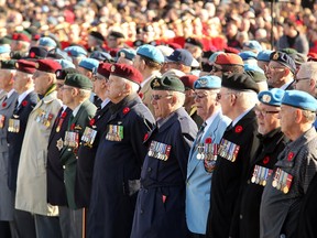 Row upon row of veterans stand before a massive crowd at the National War Memorial. Remembrance Day at the National War Memorial in Ottawa November 11, 2014.