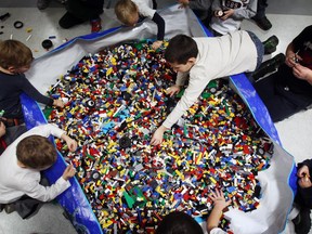 Kids play in giant pit of Lego bits at Brickfete in Ottawa on Sunday, November 16, 2014.