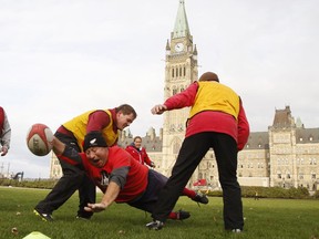 Angus Murchison dives with the ball, with the Peace Tower in the background.