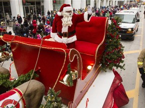 Santa Claus waves to the thousands of spectators during the 2014 Ottawa Professional Fire Fighters' Association's Help Santa Toy Parade in Ottawa Saturday