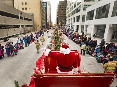 Santa Claus waves to the thousands of spectators during the 2014 Ottawa Professional Fire Fighters' Association's Help Santa Toy Parade in Ottawa Saturday.
