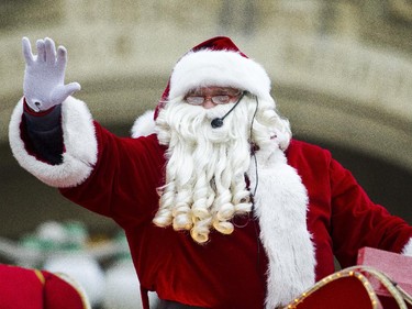 Santa Claus waves to the thousands of spectators during the 2014 Ottawa Professional Fire Fighters' Association's Help Santa Toy Parade in Ottawa Saturday