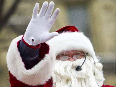 Santa Claus waves to the thousands of spectators during the 2014 Ottawa Professional Fire Fighters' Association's Help Santa Toy Parade in Ottawa Saturday