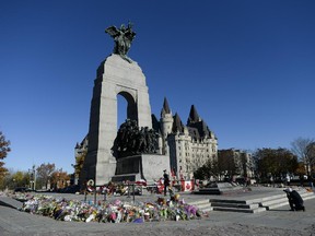 Scene of the War Memorial before Public Works and Government Services Canada and National Capital Commission begin to remove the flowers and mementos on Sunday, Nov. 2, 2014. The flowers that are still in good condition will be donated to the Perley and Rideau Veterans' Health Centre and other venterans' homes. The removal process is necessary procedure to begin the preparation for the annual Remembrance Day ceremony. (James Park / Ottawa Citizen)