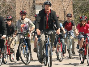 Councillor Rainer Bloess cycles with a group of students who received new bicycles through a Shenkman Family Foundation program in 2008.