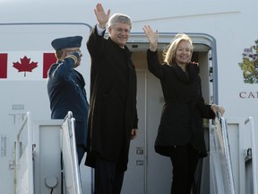 Canadian Prime Minister Stephen Harper and his wife Laureen board a government plane as they depart for China, Wednesday November 5, 2014 in Ottawa.