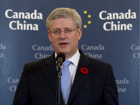Canadian Prime Minister Stephen Harper speaks with media during a news conference in Beijing, China, on Sunday, November 9, 2014.