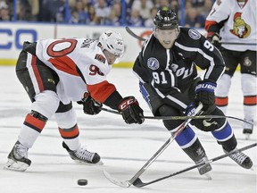 Tampa Bay Lightning center Steven Stamkos (91) cuts by Ottawa Senators right wing Alex Chiasson (90) during the second period of an NHL hockey game Saturday, Nov. 29, 2014, in Tampa, Fla.