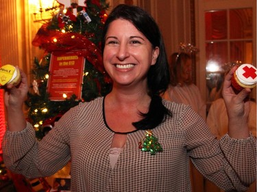 Sylvie Carbonneau from the Shaw Centre with its superhero-themed tree honouring Ottawa's emergency service responders, at the Trees of Hope for CHEO event held at and presented by the Fairmont Chateau Laurier on Monday, November 24, 2014.
