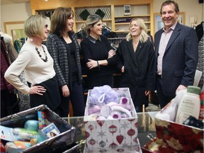 Tara Shields, co-ordinator of The Shoebox Project for Shelters (centre left), is surrounded by Ottawa business leaders who have agreed to collect donated shoeboxes filled with gift items for abused women living in shelters. Shields is flanked by Kenetha McNamee and Leslie Fraser (left) and Chantal Biro-Schad and Chris Taggart, right, of Tamarack Homes.