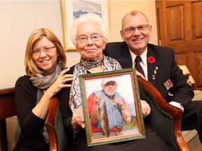 A photo of the late Antoni Miszkiel is held by his daughter Barbara, wife Teresa (Renia) and son Marian.