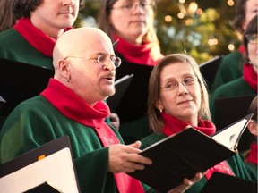 Choir director Pierre Massie sings during one of The Stairwell Carollers' concerts.