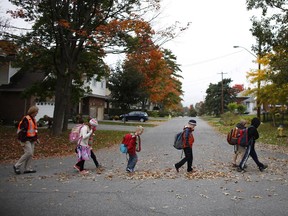 The walking school bus, a pilot project where paid adults walk large numbers of kids to school, makes its way to Woodroffe Public School on Sept. 30, 2014. (David Kawai / Ottawa Citizen)
