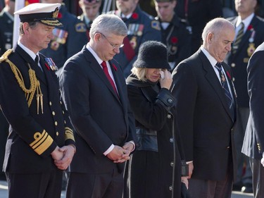 Vice Admiral Sir Tim Laurence (left), Prime Minster Stephen Harper, his wife Laureen Harper and Minister of Veterans Affairs Julian Fantino pause during the Remembrance Day ceremony at the National War Memorial in Ottawa on Tuesday, Nov. 11, 2014.