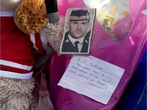 Tributes adorn the the National War Memorial in honour fo Cpl. Nathan Cirillo Thursday October 30, 2014 in Ottawa.