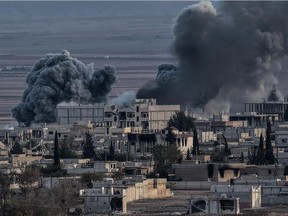 Smoke rises after an airstrike from US-led coalition in the city of Kobane, also known as Ain al-Arab, seen from the southeastern border village of Mursitpinar, Sanliurfa province, on November 9, 2014.