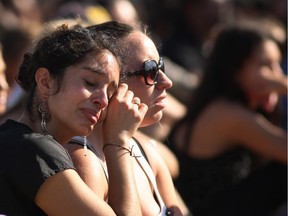 Students mourn at a public memorial service on the Day of Mourning and Reflection for the victims of a killing spree at University of California, Santa Barbara on May 27, 2014 in Isla Vista, California. Elliot Rodger killed six college students at the start of Memorial Day weekend and wounded seven other people, stabbing three then shooting and running people down in his BMW near UCSB before shooting himself in the head as he drove. Police officers found three legally-purchased guns registered to him inside the vehicle. Prior to the murders, Rodger posted YouTube videos declaring his intention to annihilate the girls who rejected him sexually and others in retaliation for his remaining a virgin at age 22.