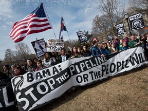 This March 2, 2014  photo shows students protesting against the proposed Keystone XL pipelinerally in Lafayette Park across from the White House in Washington,DC .