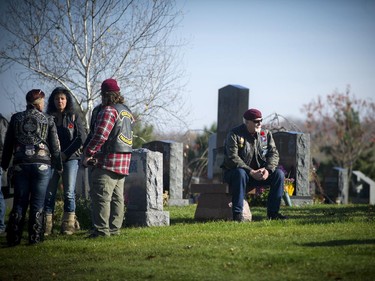 Veterans take a moment after the Remembrance Day ceremony held at the National Military Cemetery at Beechwood Cemetery Tuesday November 11, 2014.