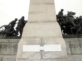 What look like new plaques — currently covered up — are seen on the National War Memorial in Ottawa on Nov. 6, 2014.