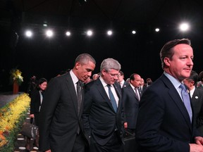 United States' President Barack Obama walks with Canada's Prime Minister Stephen Harper and United Kingdom's Prime Minister David Cameron as they leave A Call to Country performance on November 15, 2014 in Brisbane, Australia.
