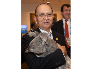 Myanmar's President U Thein Sein holds a koala.