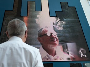 Robert Sirman, director and CEO for the Canada Council for the Arts, shows off the latest art exhibit in their new public space at 150 Elgin St. The installation, from artist Rafael Lozano-Hemmer, is called The Year's Midnight, 2011, and features a plasma screen, computer, webcam, and custom software. Stare at the screen the right way and your eyes begin to "smoke." (Photo by Wayne Cuddington/ Ottawa Citizen)