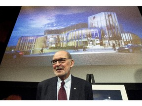 Peter Herrndorf, the president and CEO of the NAC (National Arts Centre) in Ottawa, stands in front of a drawing of the renovated centre.