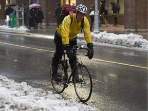 Cyclists on Bank S. Mild weather with an expected hight of plus 1 C resulted in a freezing rain warning and school bus cancelations. Two-to-four cms of snow are expected overnight.  (Pat McGrath / Ottawa Citizen)