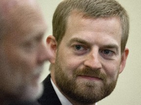 Ebola survivor, Dr. Kent Brantly, listens to an introduction by Samaritan's Purse Vice-president Ken Isaacs. Brantly spoke in Ottawa, Friday, discussing the strategy for treating the Ebola outbreak in West Africa.