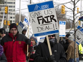 Corrections officers picket outside Community Minister Yasir Naqvi's office in Ottawa on Dec 8. 2014.