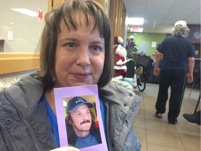 Corinne Jackson holds a photo of her former boyfriend Rene Wilkinson after his memorial service at The Oaks on Tuesday. Wilkinson, a longtime resident of The Oaks, died Dec. 6 at age 54.