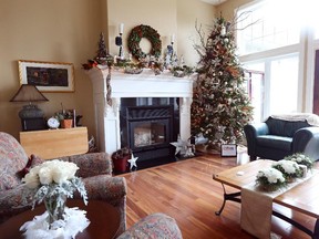 The tree that dominates the great room is a resting spot for a host of owls. Other unusual touches include bare branches and poinsettias made of cork. Floral arrangements in white are dispersed around the room.