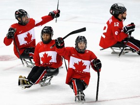 Tyler McGregor of Canda (2R) waves to the crowd after winning the Ice Sledge Hockey Bronze Medal match between Canada and Norway at the Shayba Arena during day eight of the 2014 Paralympic Winter Games on March 15, 2014 in Sochi, Russia.