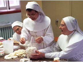 In this 1997 file photo, from left Sister Marie- Germaine, Sister Marie Quynh and Sister Jacqueline of the cloistered convent 'Les Servantes de Jesus-Marie' package communion wafers.