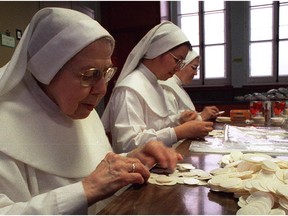 In this 1997 file photo, from left, Sister Marie- Germaine, Sister Marie Quynh and Sister Jacqueline prepare communion wafers at the cloistered convent 'Les Servantes de Jésus-Marie' in the Old Hull sector of Gatineau.